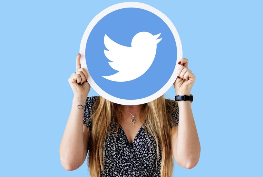 Woman showing a Twitter icon